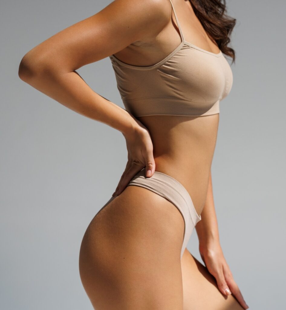 woman body in lingerie over gray background